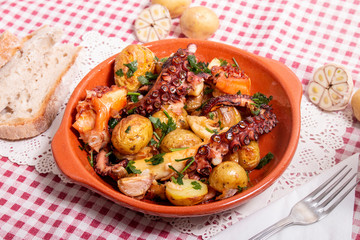 Grilled ocotpus with potatoes, garlic and salsa.