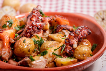 Grilled ocotpus with potatoes, garlic and salsa.