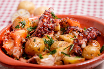 Grilled ocotpus with potatoes, garlic and salsa.