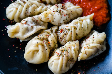Georgian Dumplings Khinkali with Meat, Tomato Sauce and Spices / Hingel.
