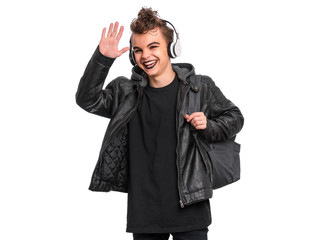 Happy teen boy student with backpack in style of punk goth dressed in black, isolated on white...