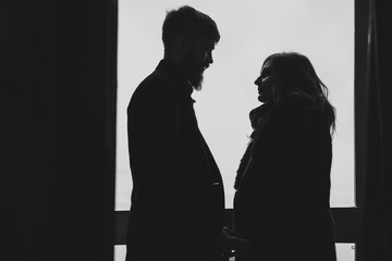Silhouette of a happy couple looking at each other
