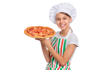 Happy beautiful teen girl in chef hat holding cooked pizza. Girl cook in apron holds plate with fresh pizza, isolated on white background. Portrait of cute child showing delicious Italian pizza.