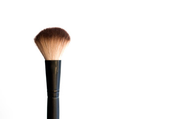 Black makeup brush on a white background.