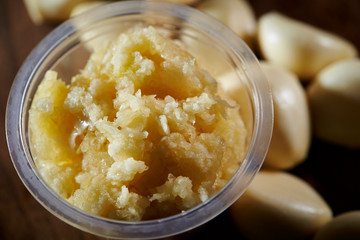 Crushed garlic in plastic bowl 