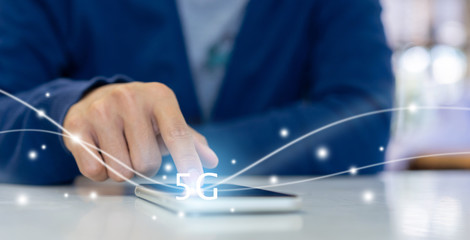 close up telecommunication engineer man hand touching on smartphone screen to test 5G frequency radio signal before installing with virtual digital display for improvement technology concept