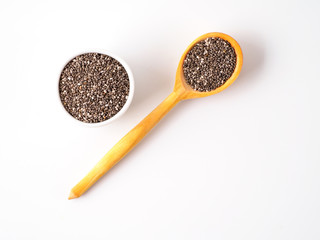 Chia seeds isolated on white background in different dishes.