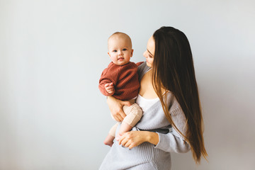 Happy mother holding up her baby girl