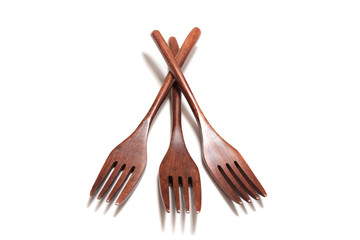 wooden forks over white background