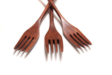 wooden forks over white background