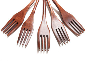 wooden forks over white background