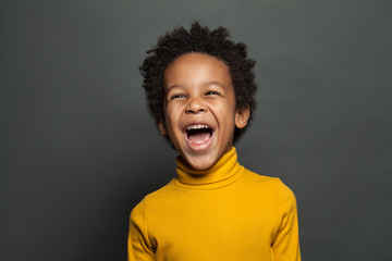Laughing kid on gray background