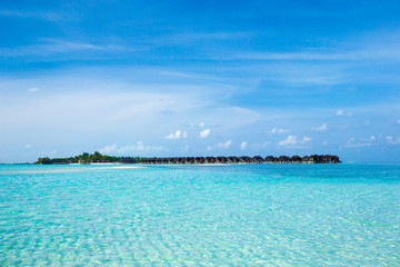 Fototapeta premium Beautiful tropical Maldives island with beach. Sea with water bungalows