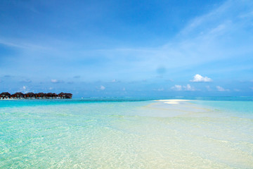 Naklejka na ściany i meble Beautiful tropical Maldives island with beach. Sea with water bungalows