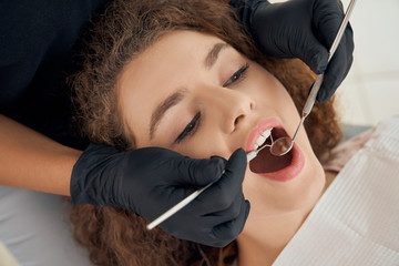 Charming girl checking up her teeth at modern clinic