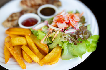 Grilled meat, Porkchops steak with pepper sauce and salad.