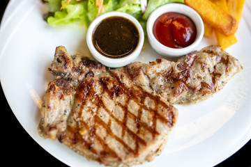 Grilled meat, Porkchops steak with pepper sauce and salad.