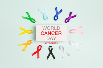 World cancer day concept, February 4. Colorful awareness ribbons on blue background.