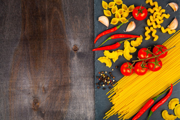 Fototapeta na wymiar Spaghetti, tomatoes, chili peppers and spices