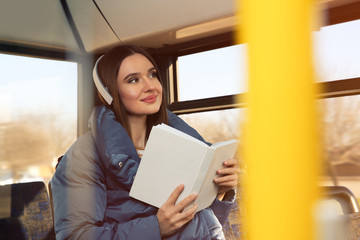 Woman listening to audiobook in trolley bus