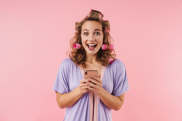 Image of young happy woman smiling and using cellphone