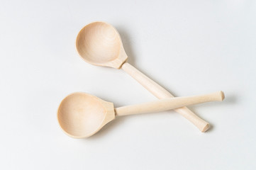 two wooden spoons on a white background, blanks for your design, top view