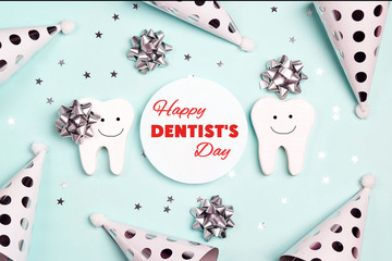 Happy Dentist's Day greeting card with teeth and holiday caps on a blue.