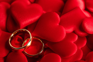 Golden wedding rings on red