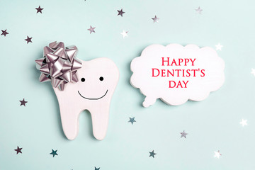 Dentist's Day greeting card with tooth and speech bubble on a blue.