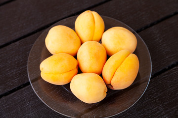 Fototapeta na wymiar Ripe apricots on a wooden table.
