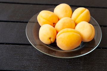 Naklejka na ściany i meble Ripe apricots on a wooden table.