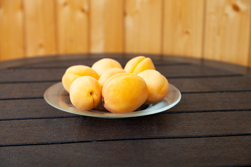Ripe apricots on a wooden table.
