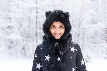 Season and people concept - Beautiful young woman winter outdoor portrait.