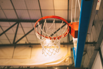 Interior of school gym with basketball board and basket