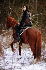 a Viking girl riding a red horse painted in black runes