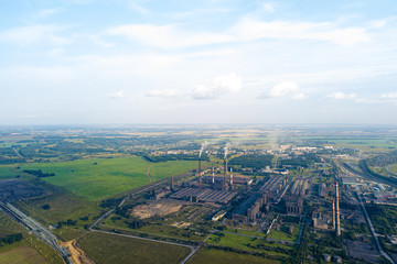 Aerial view of a large plant with mines for the extraction of coal. Mounds of black coal near production and industry. Environmental problems.