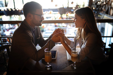 Attractive elegant young couple in love dating at the restaurant.