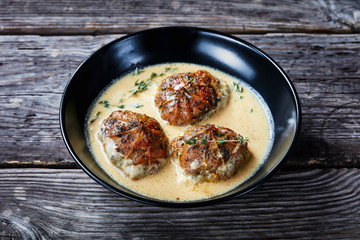 rabbit ballotine in a black bowl, close-up