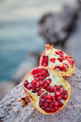 ripe organic pomegranate on the stone background