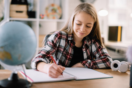 Young girl doing homework. Beautiful little girl at home learning 