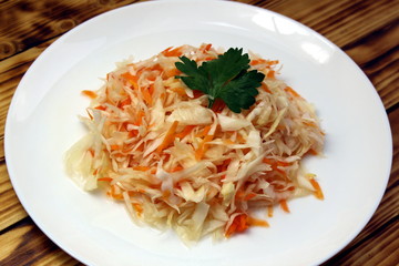 Shredded coleslaw with carrots sauerkraut in a plate