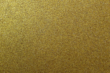 Texture shiny surface with small grains of golden colo