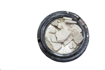 In the container is a broken eye shadow