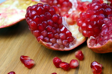 Open pomegranate with peel on a wooden table