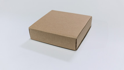 Cardboard box. Side View. With shadows and isolated on white.