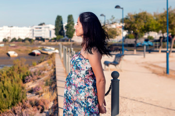 Pregnant woman poses on the marshlands.
