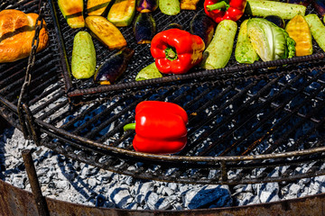 Different vegetables cooking on a grill at country fair