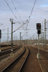 Railway track with trains and forest in the background