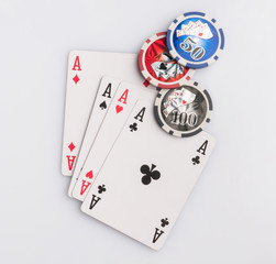 Poker chips and cards on a white background. The concept of gambling and entertainment. Casino and poker
