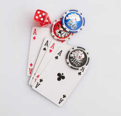 Poker chips, cards and dice on a white background. The concept of gambling and entertainment. Casino and poker